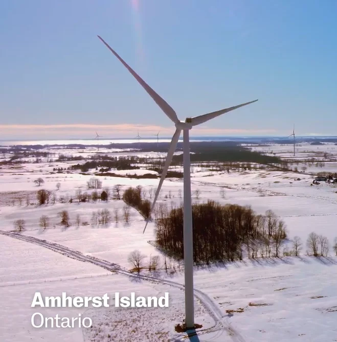 Wind turbine in a snowy field in Amherst Island, Ontario, US
