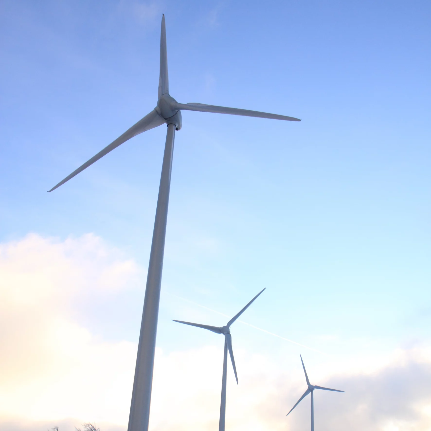 Three wind turbines in the blue sky